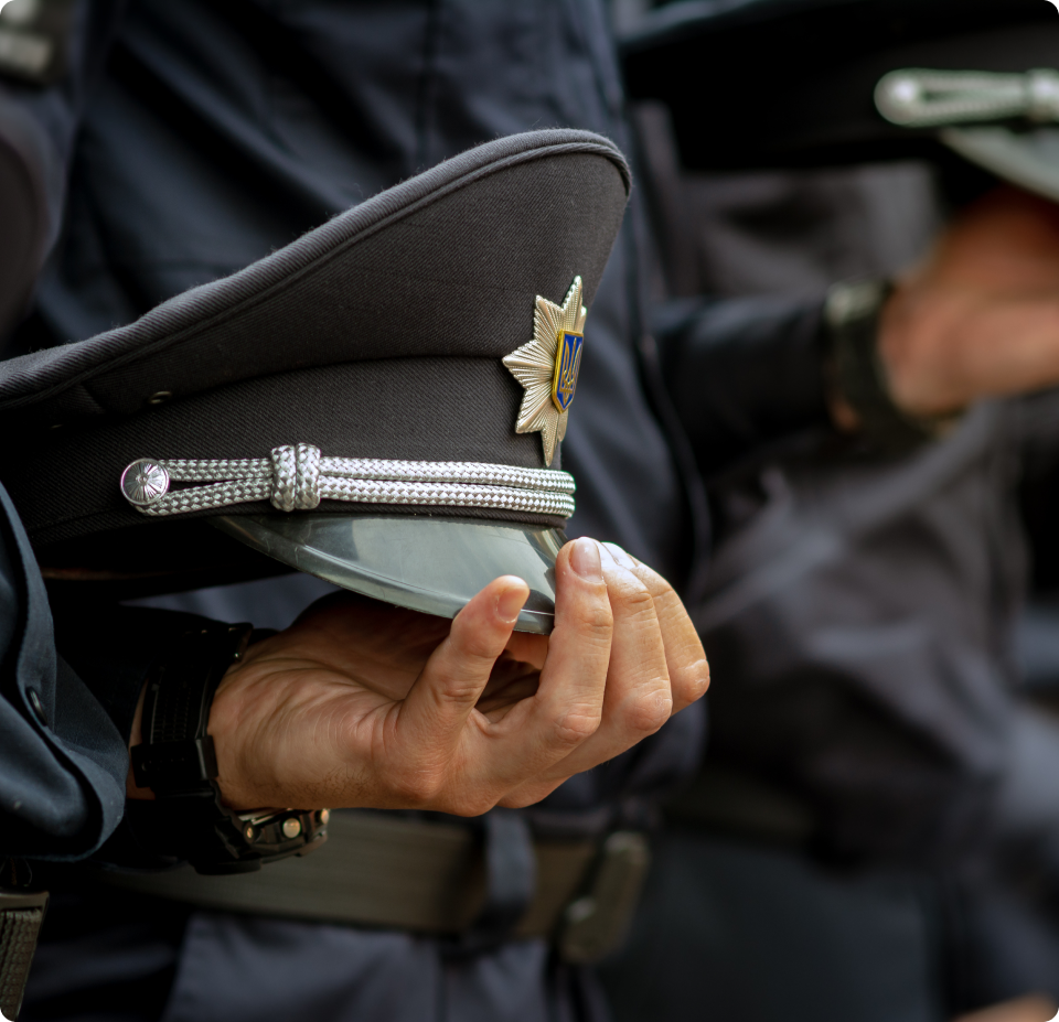 Hand holding law enforcement hat